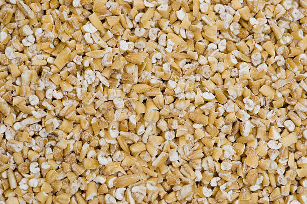 Steel Cut Oats Detailed close-up image of steel cut oats, shown to reduce cholesterol when eaten for breakfast daily. steel cut oats stock pictures, royalty-free photos & images
