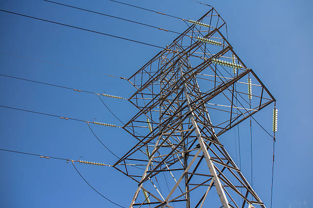 Steel pylon for high voltage power lines against blue sky stock photo