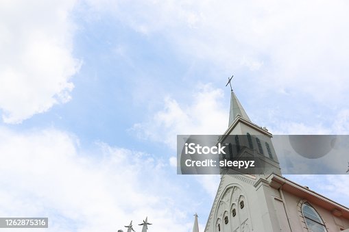 istock steeple of public church with blue sky in the background 1262875316