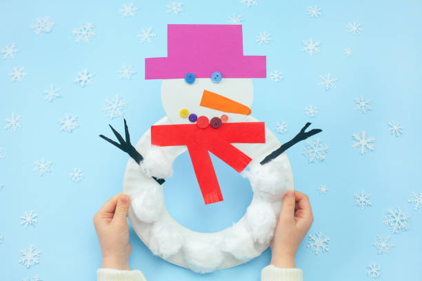 Step-by-step instruction of christmas snowman from a Paper Plate. Final result stock photo