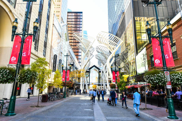Stephen Ave in Calgary, Alberta,Canada Pedestrians walking past retail outlets along Stephen Ave in Autumn, Calgary, Alberta. Stephen Ave is a famous pedestrian mall in downtown Calgary calgary stock pictures, royalty-free photos & images