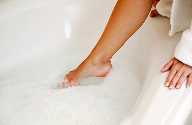 Stepping into a foam bath. stock photo
