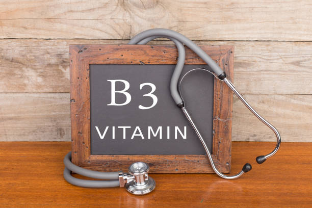 stethoscope and blackboard with text "Vitamin B3" on wooden background stock photo