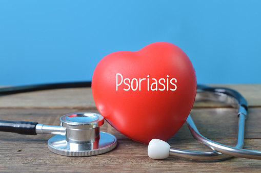 Stethoscope and red heart shape with text Psoriasis