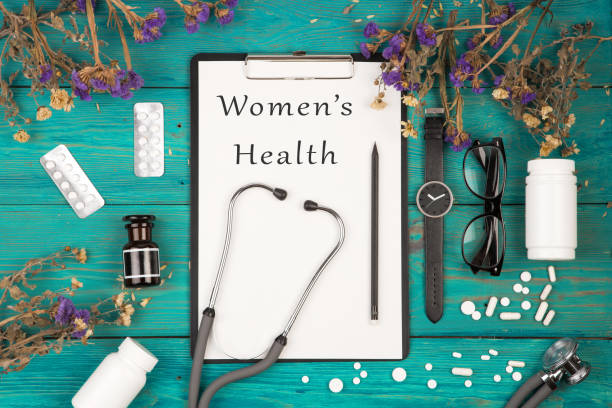 stethoscope, medicine clipboard with text "Women's Health" stock photo
