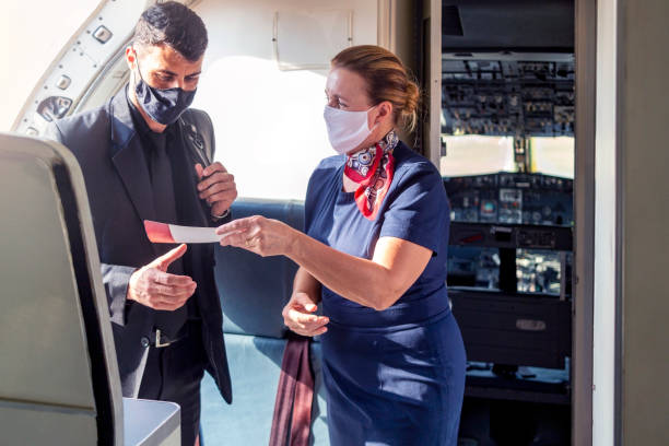 Stewardess welcoming a passenger stock photo