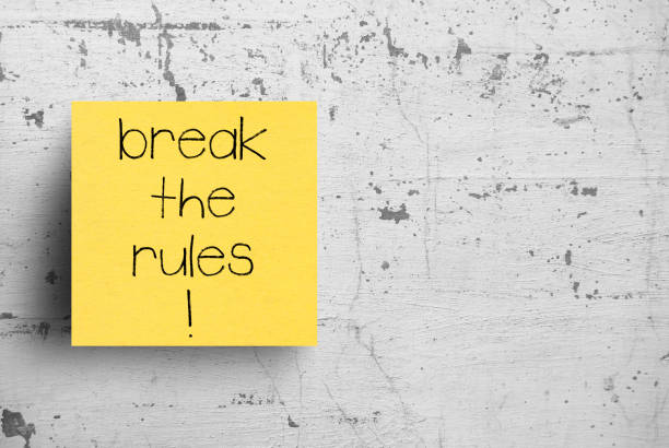Sticky note on concrete wall, Break the rules Sticky note on concrete wall, Break the rules rule breaker stock pictures, royalty-free photos & images