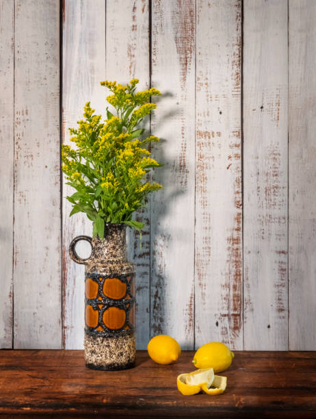 Still Life Floral Of Goldenrod In A Vintage Vase stock photo