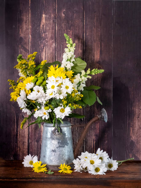 Still Life Flower Arrangemnt In An Old Watering Can stock photo