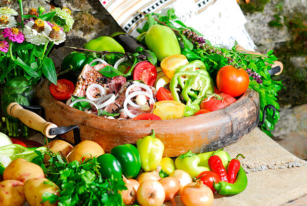 still life from vegetables and meat on the earthen dish stock photo