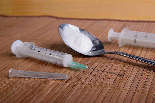 Still life with a drug Disposable syringe and a white powder in the spoon, selective focus mephedrone stock pictures, royalty-free photos & images