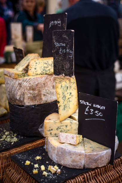 Stilton Cheese For Sale at a Market Stall in England Cheese for Sale at the Market in Frome Somerset England somerset england stock pictures, royalty-free photos & images