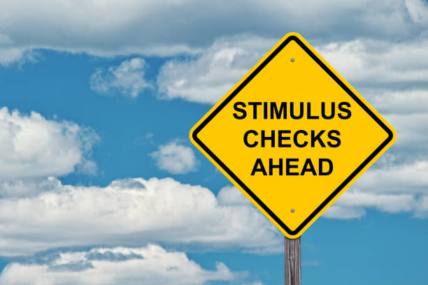 Stimulus Checks Ahead Waring Sign Stimulus Checks Ahead - Caution Sign Blue Sky Background stimulus check stock pictures, royalty-free photos & images