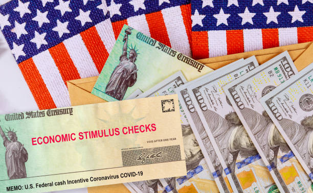 Stimulus financial a bill individual checks from government US 100 dollar bills currency American flag Global pandemic Covid 19 lockdown Stimulus financial bill individual checks from government US 100 dollar bills currency Global pandemic Covid 19 lockdown on American flag stimulus check stock pictures, royalty-free photos & images