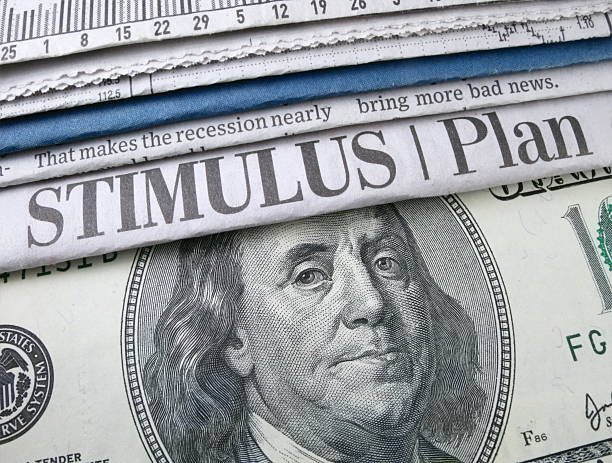 Stimulus Plan Headline Newspaper headline "Stimulus Plan" and currency economic stimulus stock pictures, royalty-free photos & images