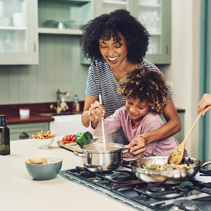 Mother cooking with daughter.