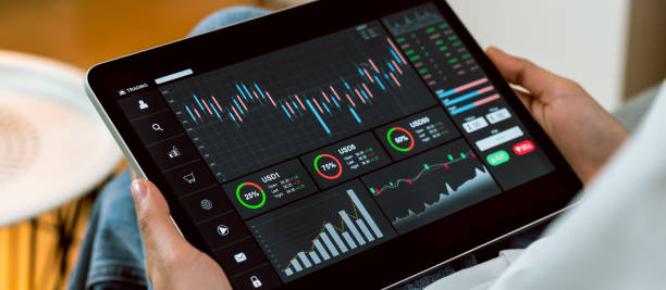 Stock exchange market concept, Hand trader touch on digital tablet with graphs analysis candle line on the table in house, diagrams on screen. stock photo