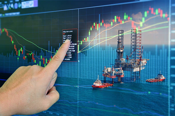 Stock market concept with oil rig in the gulf Stock market concept with oil rig in the gulf and oil refinery industry background,Double exposure oil and gas stock pictures, royalty-free photos & images