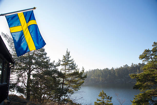 Stockholm Archipelago early spring morning, Swedish flag. stock photo