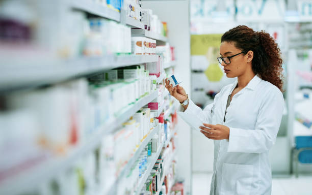 Shot of a young woman filling a prescription while working in a chemist