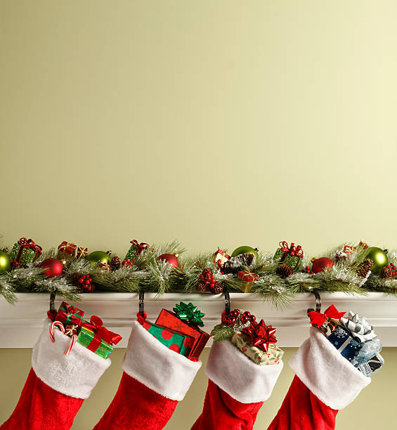 Stockings On Mantelpiece Christmas stockings hanging from a mantelpiece.To see more holiday images click on the link below: christmas stocking stock pictures, royalty-free photos & images