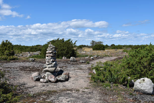 Stone cairn by a trail in a barren landscape stock photo