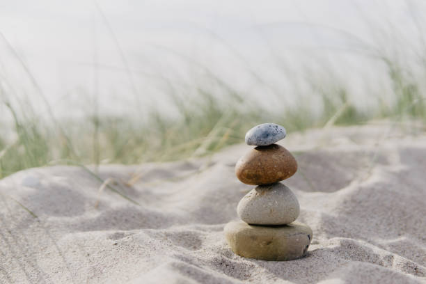 stone cairns at the beach, baltic sea stone cairns in the sand, baltic sea tranquil scene stock pictures, royalty-free photos & images