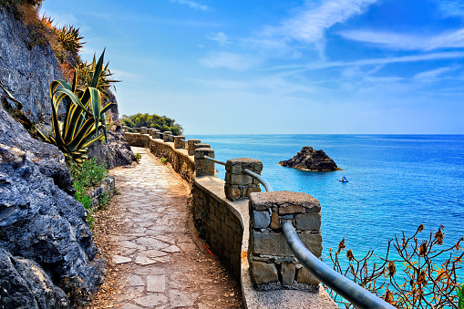 Cinque Terre, Italy. Stone hiking path along the brilliant blue sea.