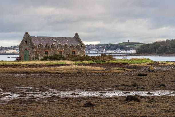 Stone house in Strangford lough with Portaferry village in background Stone house in Strangford lough with Portaferry village in background, Northern Ireland, UK strangford lough stock pictures, royalty-free photos & images