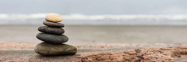 stack of stones in perfect balance on the beach in new zealand