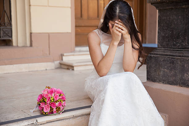 Stood up at the altar Hopeless bride crying outside a church after being stood up on her wedding day bride stock pictures, royalty-free photos & images