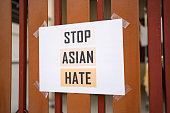 istock Stop Asian Hate sign was attached on the house fence 1303459965