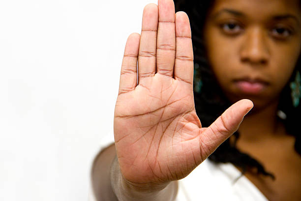 stop gesture of woman hand  sign serious facial expresion - violence against women stok fotoğraflar ve resimler