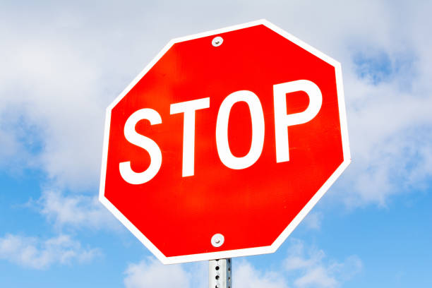 Stop sign Stop sign with blue skies and clouds in the background. stop stock pictures, royalty-free photos & images