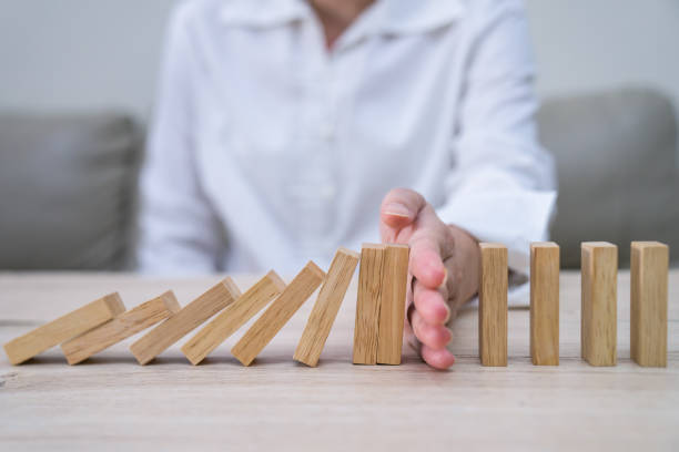 Stopping the domino effect concept for business solution, strategy and successful intervention stock photo