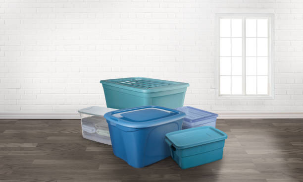 storage totes boxes in an empty room with a window storage tote boxes in an empty room with a window plastic container stock pictures, royalty-free photos & images