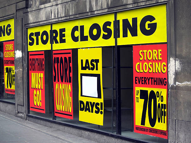 Store Closing and discount signs in department store windows stock photo
