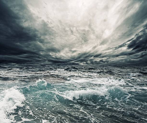 storm clouds over a churning ocean - tsunami 個照片及圖片檔