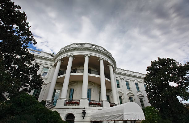 Storm Clouds Over the White House Shot of dramatic skies over the White House. white house stock pictures, royalty-free photos & images