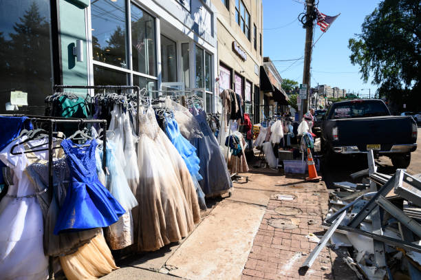 Storm-Flood Damage Millburn, New Jersey, USA - September 3, 2021: Stores empty out merchandise on the street after water damage post tropical storm. new jersey street flooding stock pictures, royalty-free photos & images