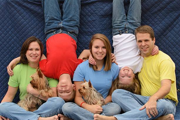 Strange awkward family photo Really goofy family photo with kids hanging upside down, horizontal. embarrassment photos stock pictures, royalty-free photos & images