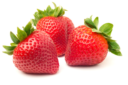 Three fresh ripe red strawberries, isolated on white with soft shadow.