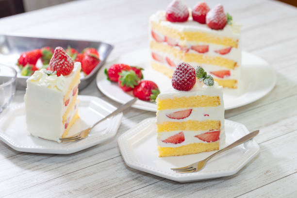 Strawberry and cream sponge cake on white wooden table Strawberry and cream sponge cake on white wooden table dessert sweet food stock pictures, royalty-free photos & images