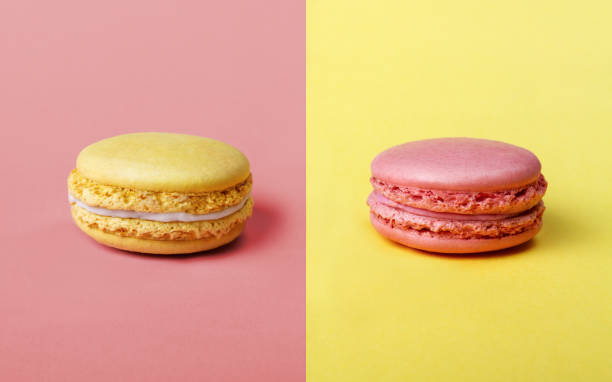 Strawberry and Lemon flavor french Macarons Pink and yellow french Macarons opposites attract position symmetry stock pictures, royalty-free photos & images
