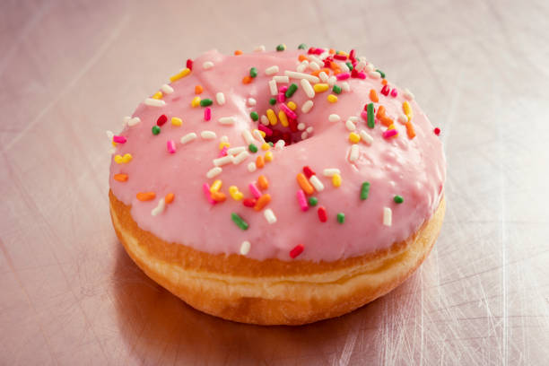 Strawberry Flavored Donut with Colorful Sprinkles stock photo