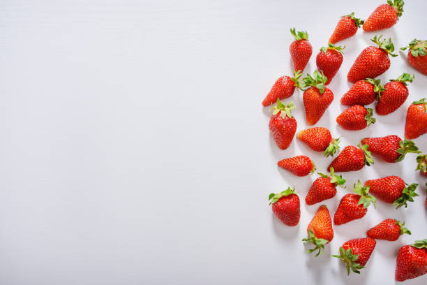 strawberry fruits on the right side on wooden background with copy space. View from above. stock photo