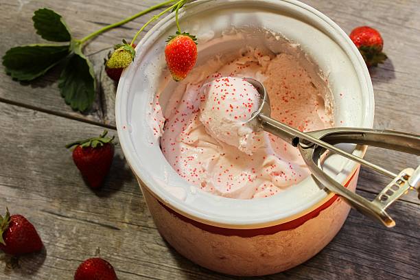 Strawberry ice cream in ice ccream maker stock photo
