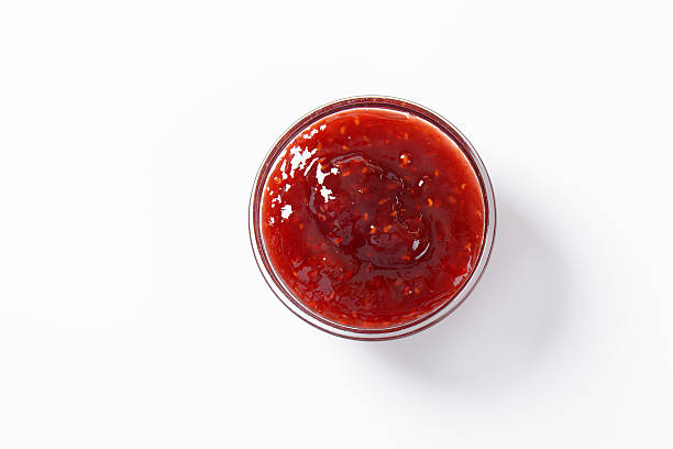 strawberry jam bowl of strawberry jam on white background marmalade stock pictures, royalty-free photos & images