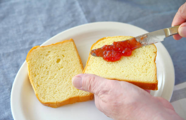 Strawberry jam spread on bread stock photo