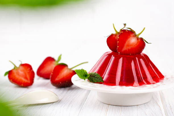 Strawberry jelly on white plate. Summer dessert with fruit jelly and fresh strawberry. Strawberry jelly on white plate. Summer dessert with fruit jelly and fresh strawberry. gelatin stock pictures, royalty-free photos & images